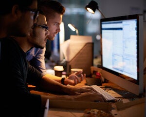 two men working on computer