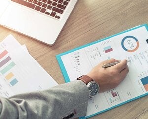 Businessman analyzing investment charts.