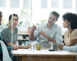 conference room with a group of business professionals sitting around the table