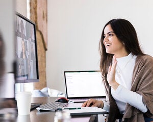 Woman enjoying a video conferencing on her desktop computer