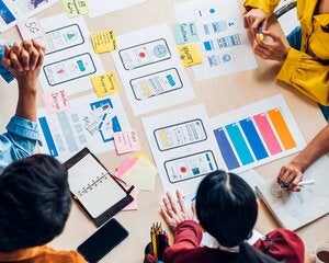 Students looking over UX layouts