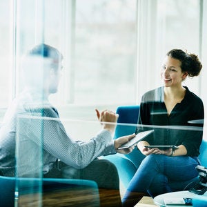 two business professionals sitting in office