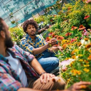 two individuals in a greenhouse