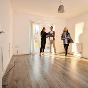 Real estate agent showing investors interior of property