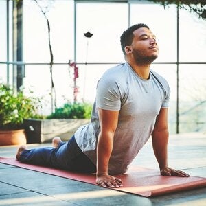 man practicing yoga pose