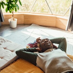 man meditating on the floor of his living room