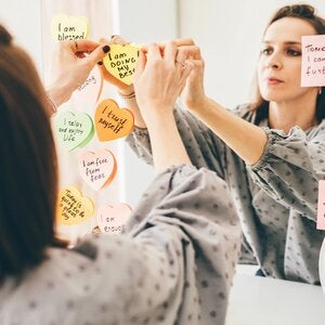 woman with words of affirmation on her mirror