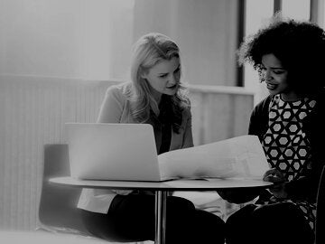 Two businesswomen discussing finances