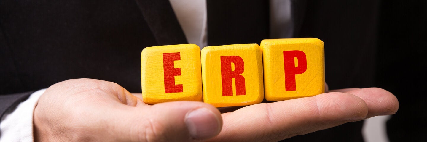 Man holding blocks that spell out ERP