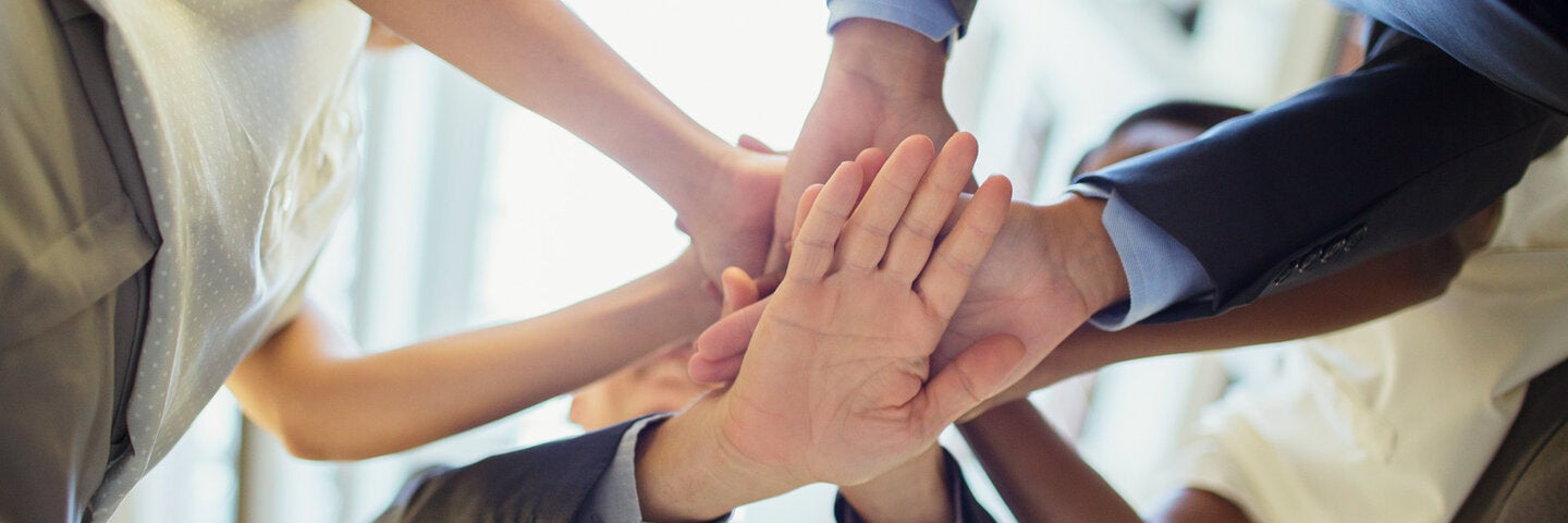 circle of people with hands in the middle