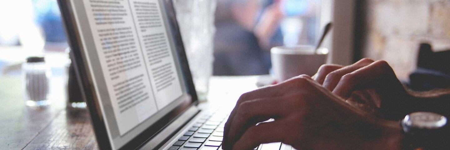 Man writing business email on laptop