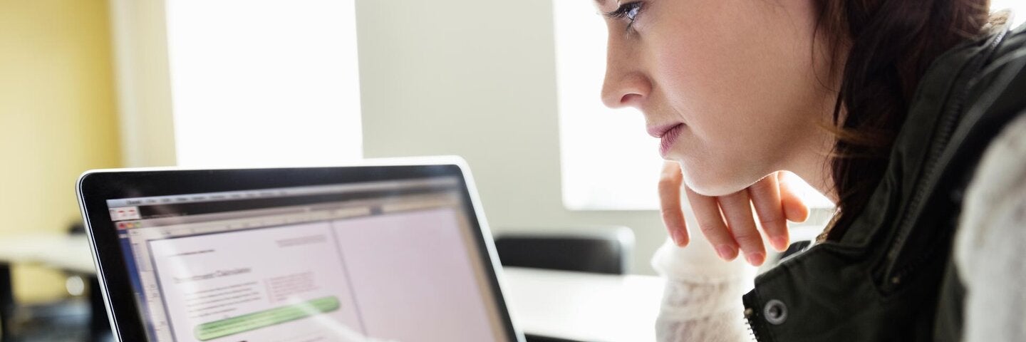 woman looking at laptop screen