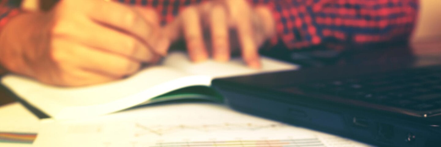 man working on financial document