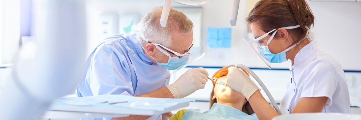 Dentist and hygienist performing a dental procedure.
