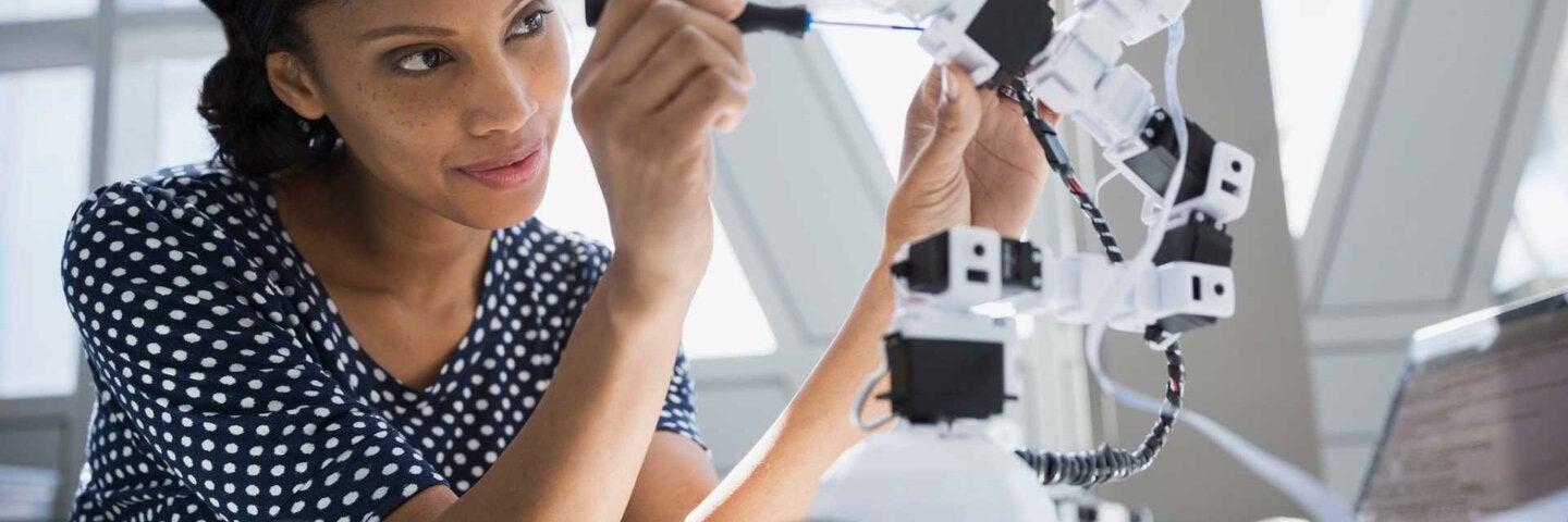 Female engineer working on robotics