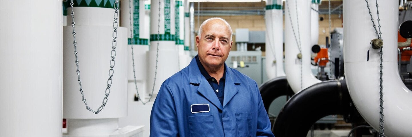 picture of a gentleman in front of HVAC equipment