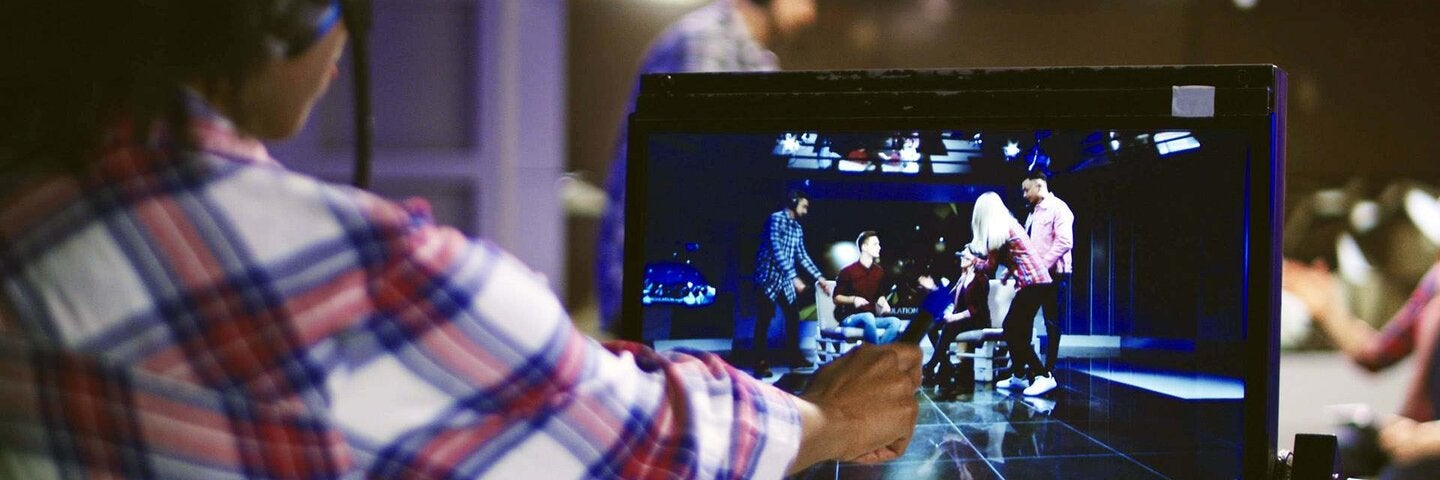 Woman in headset controlling process of shooting TV show