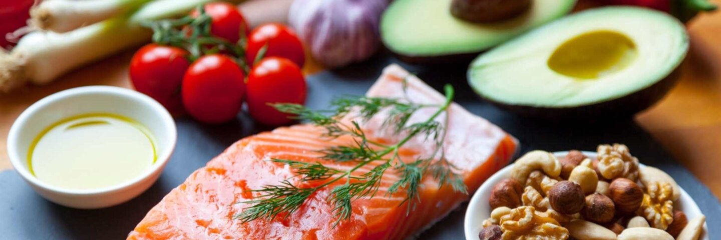 Platter with fresh ingredients, salmon, nuts, and avocado