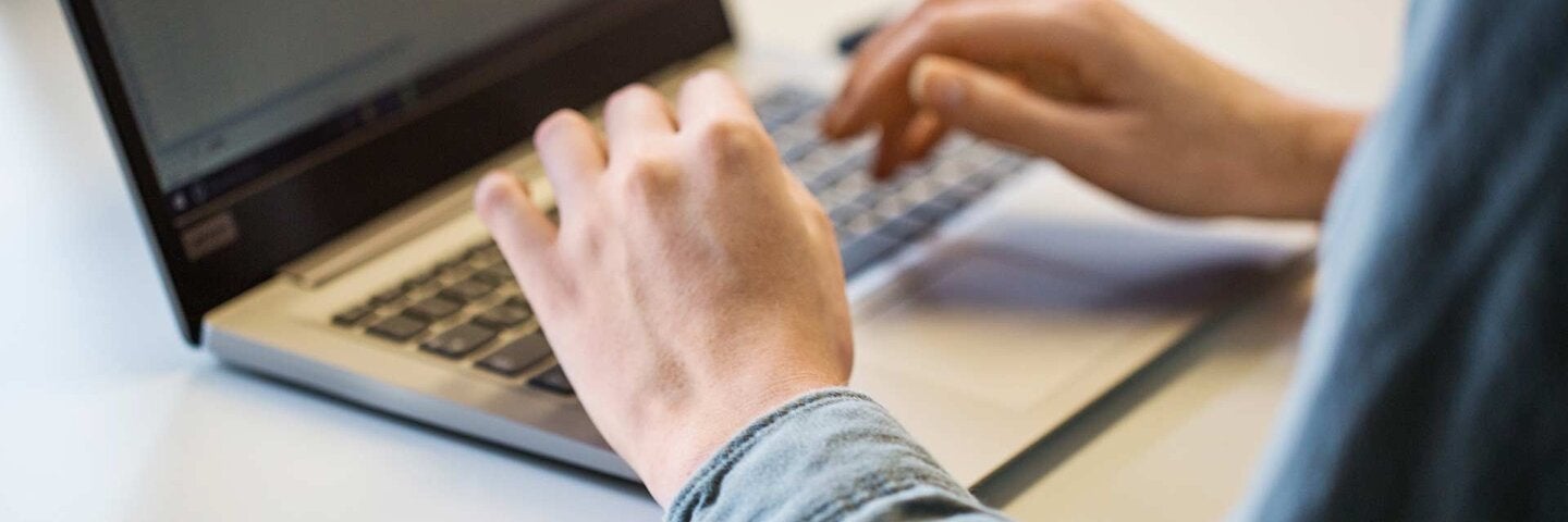 man's hands on laptop