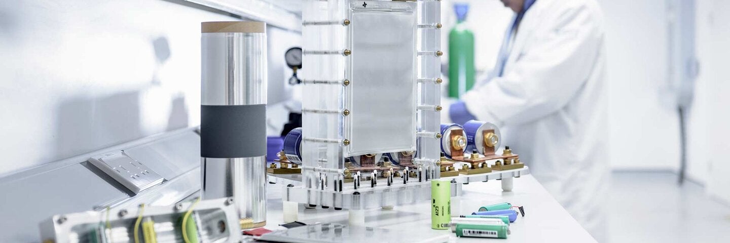Scientist assembles lithium ion battery samples in battery research facility