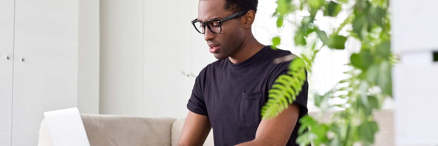 man typing on laptop