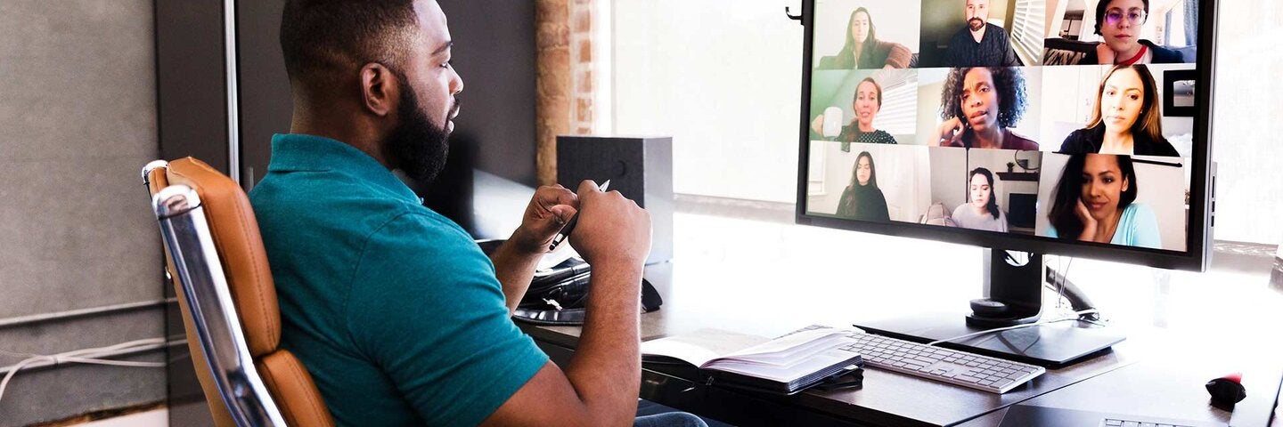 Mid adult manager video conferences with his team