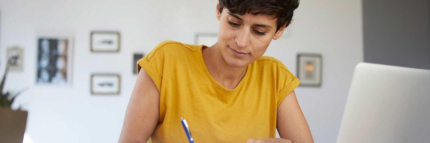 Woman working at table at home