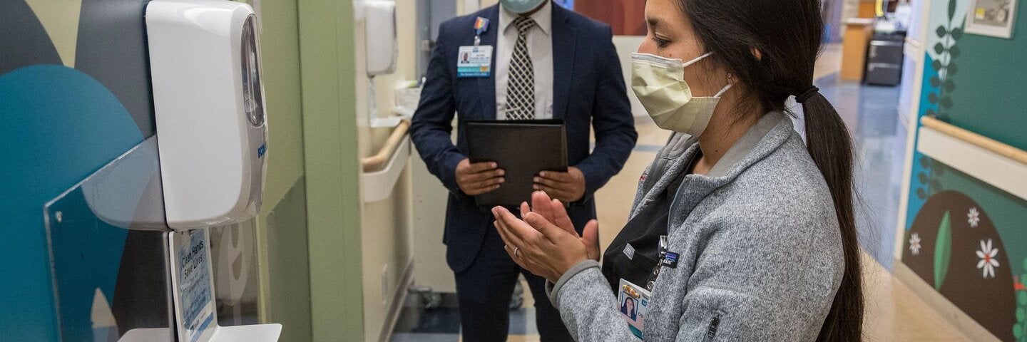 Healthcare workers using sanitizer