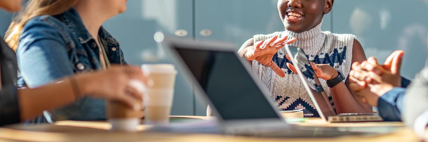 students smiling around a table