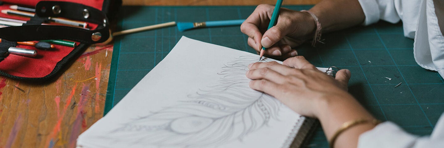 woman drawing a feather