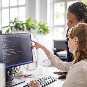Two people at a computer screen