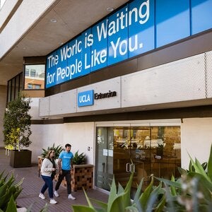 Students walking into UCLA Extension main entrance at the Gayley Center